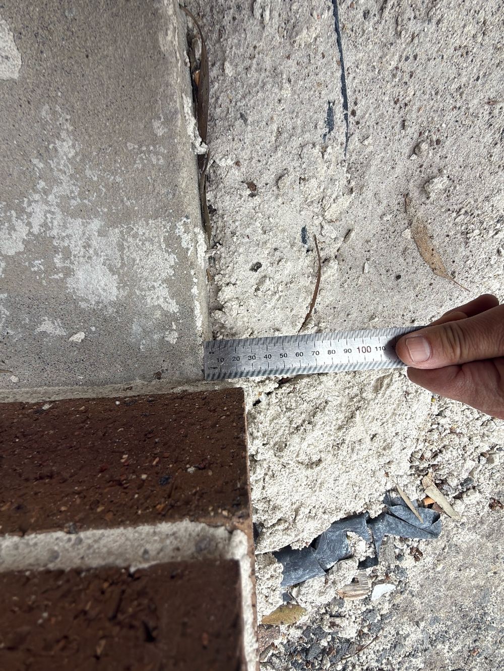 Wall built off its set-out line, overhanging the slab by over 15mm, found during a defect investigation inspection in Reservoir