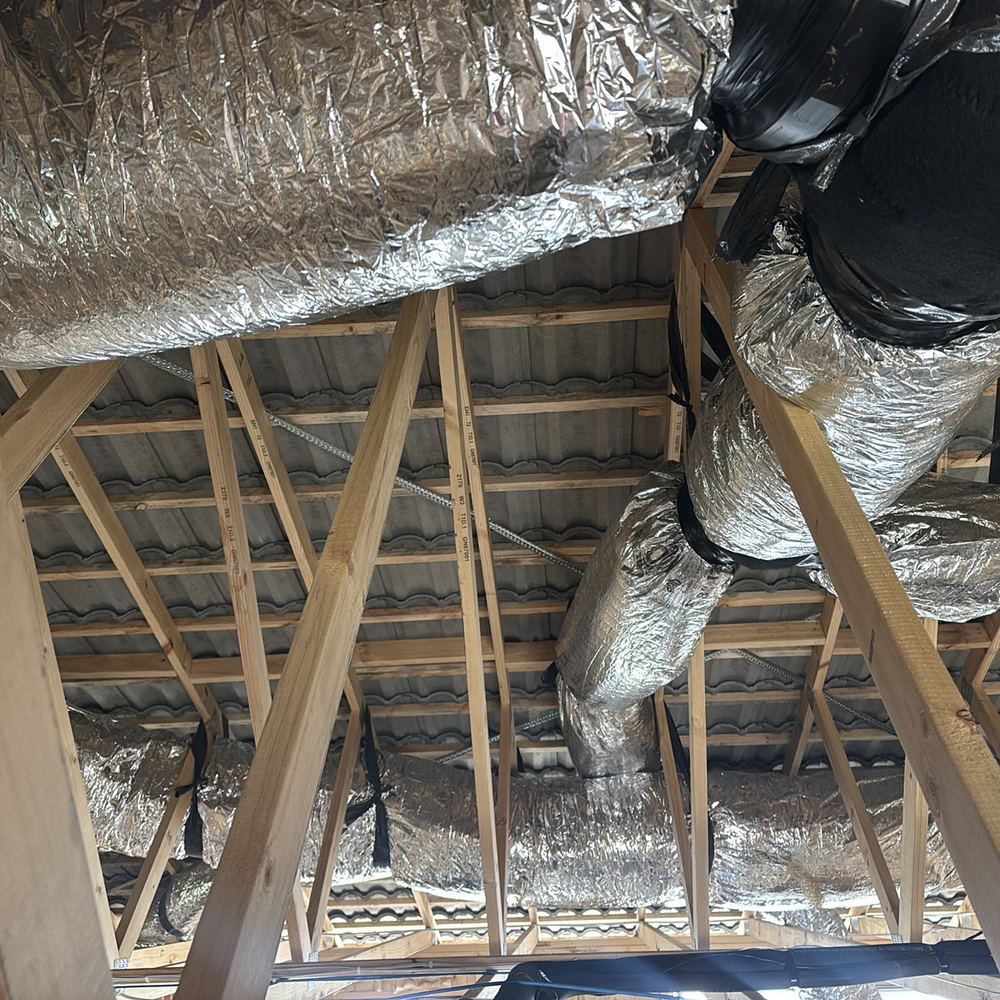 No sarking under the tiled roof, with the builder asked to confirm the requirement, found during a lock-up inspection in Kalkallo