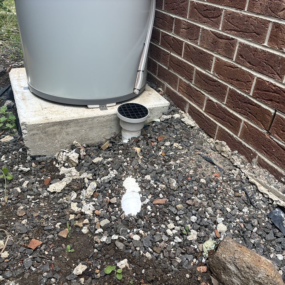 Stormwater pipe without enough soil cover, leaving it open to damage, found during a pre-handover inspection in Kalkallo