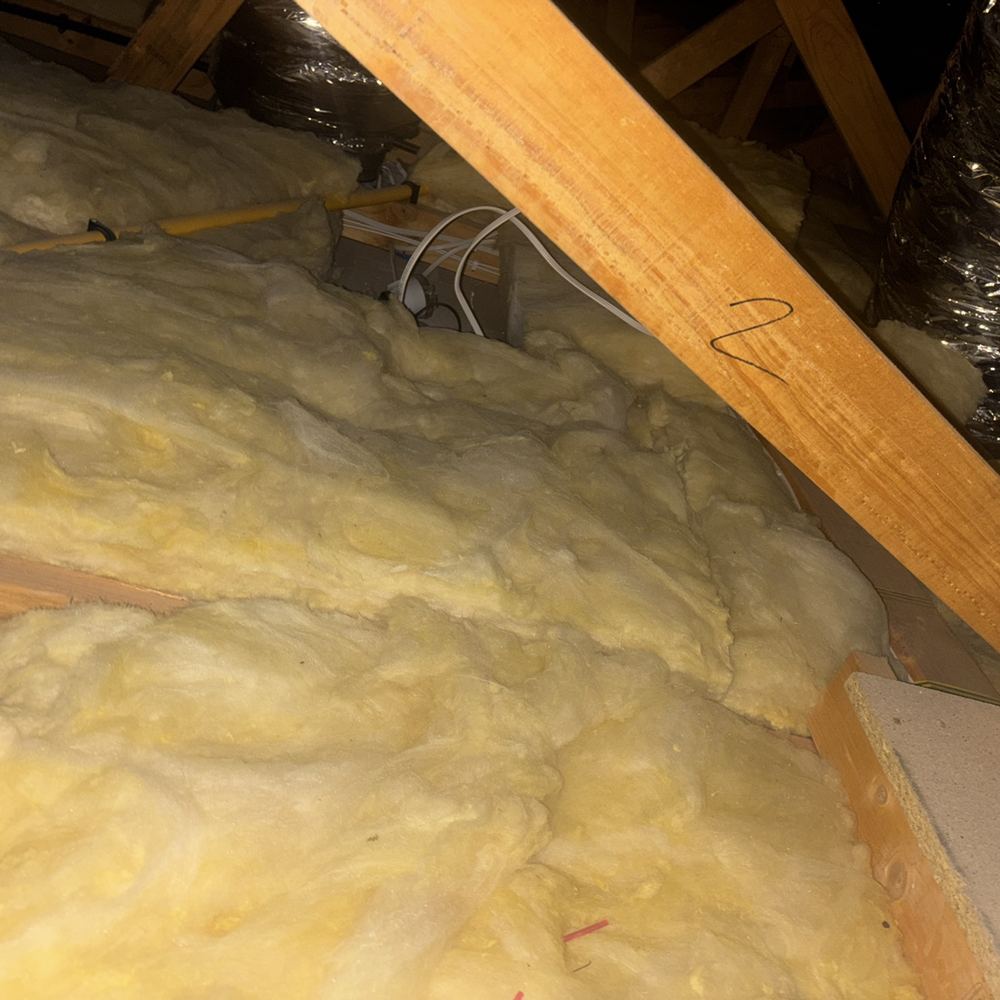 Downlight buried in insulation without the clearance that limits fire risk, Kalkallo