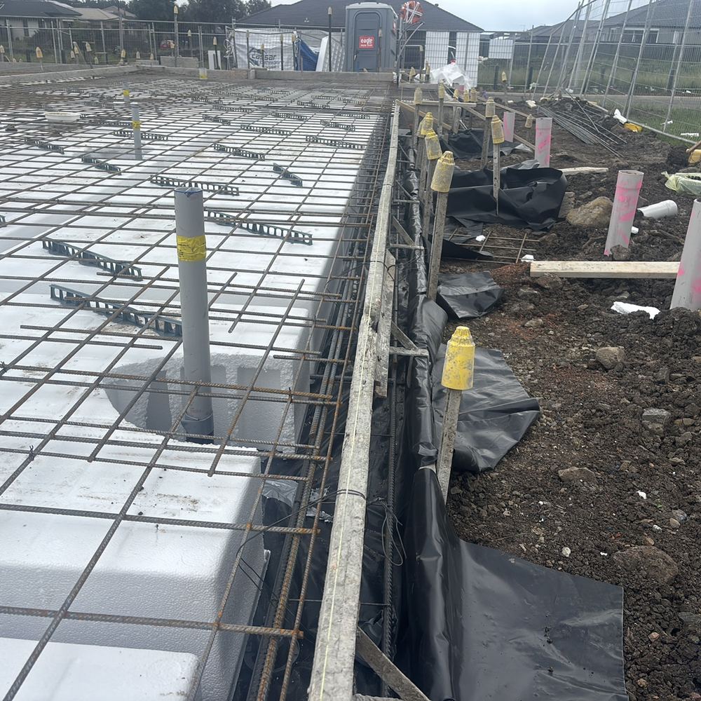 Formwork boards out of line, needing bracing so the slab edge pours straight, Kalkallo