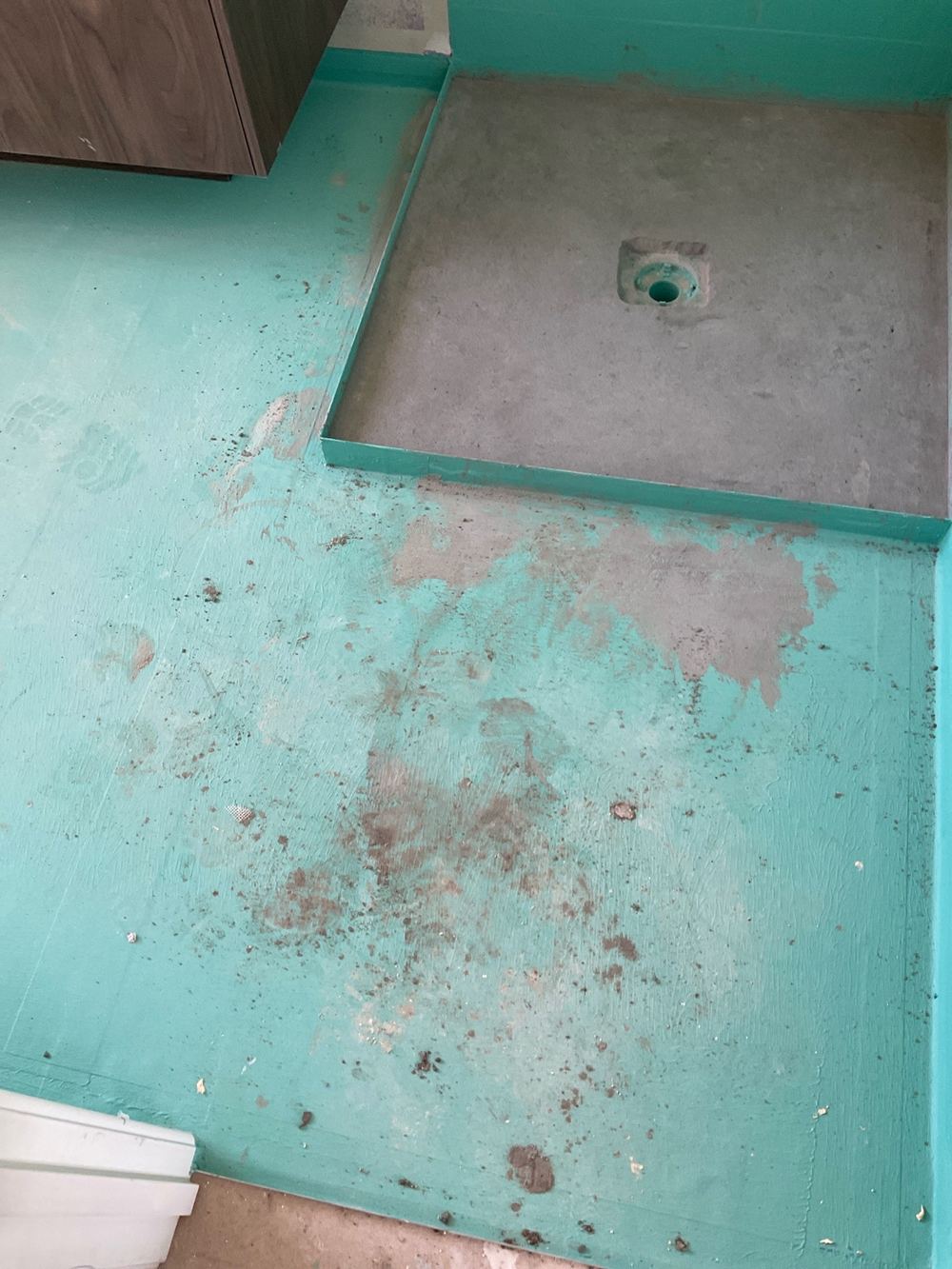 Fresh membrane left exposed to foot traffic and site damage before tiling, Kalkallo