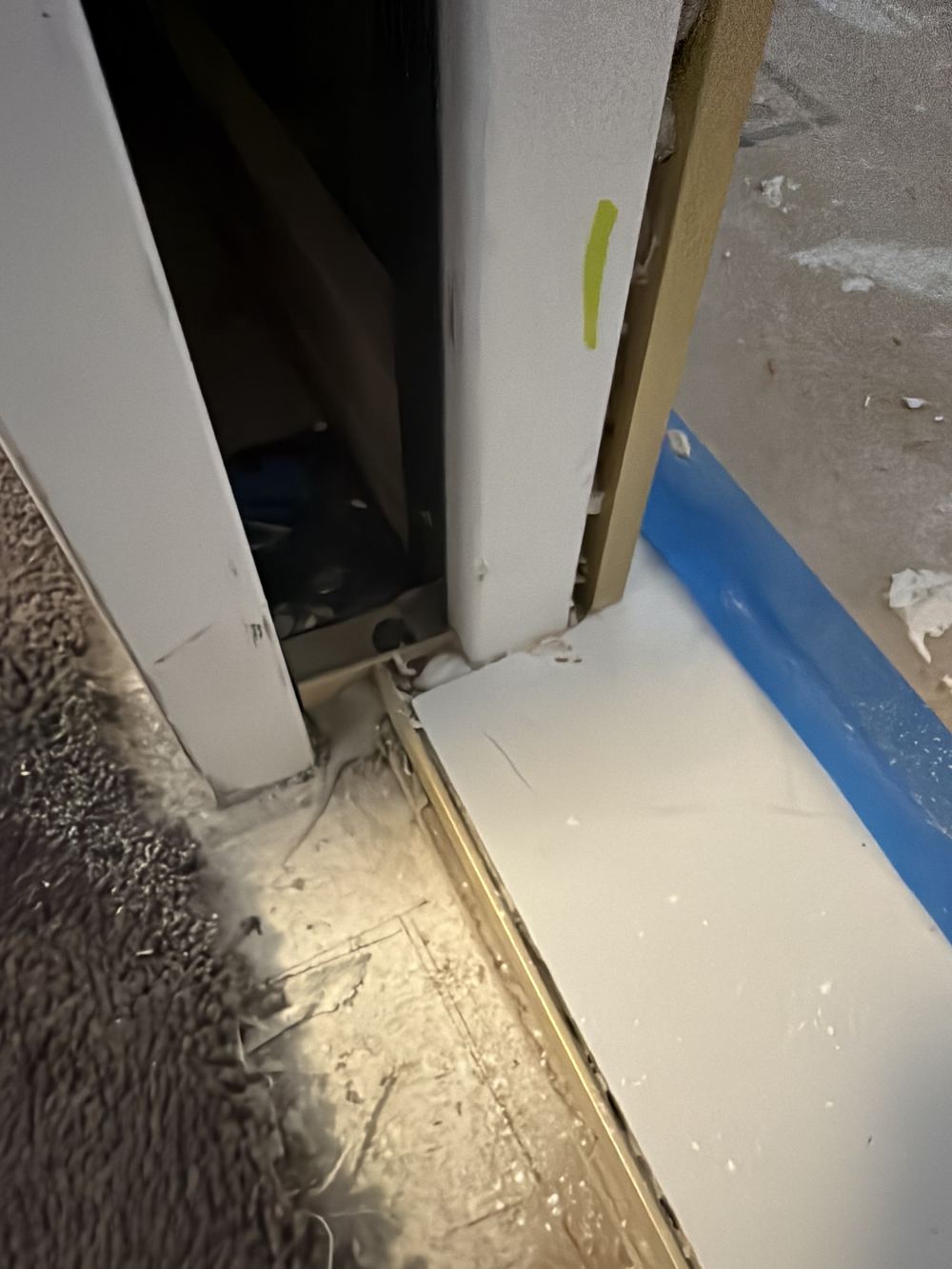Doorway waterstop not joined to the wall flashing at the door jambs, found during a waterproofing inspection in Chelsea
